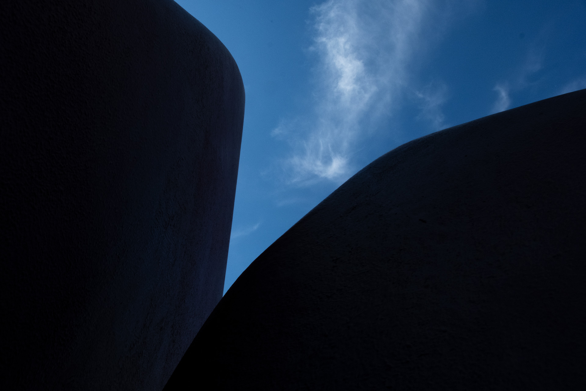 a colour photo of a blue sky obscured by a sculptural object